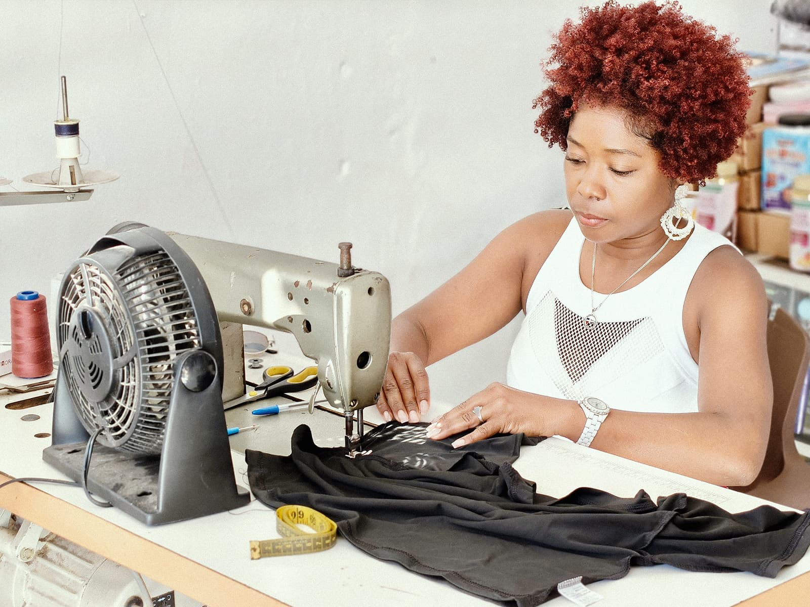 A tailor sewing at her machine